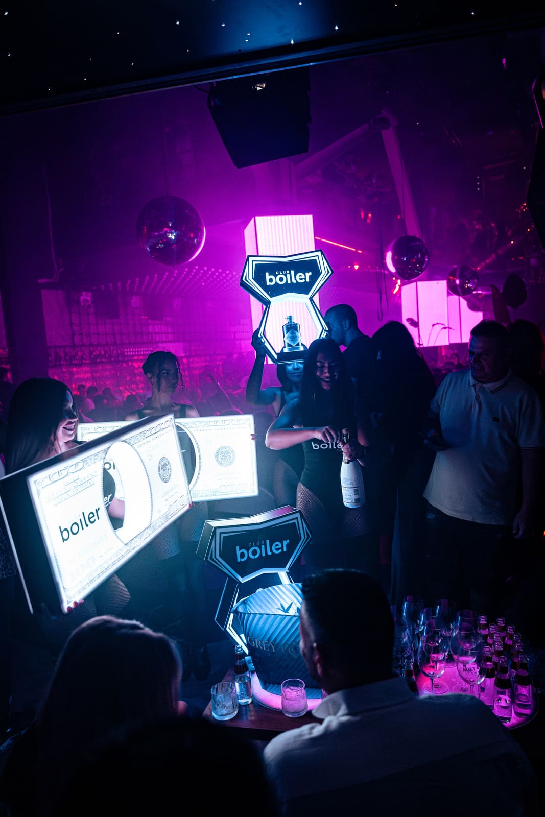 Bottle service presentation with LED signs and dancers at Club Boiler